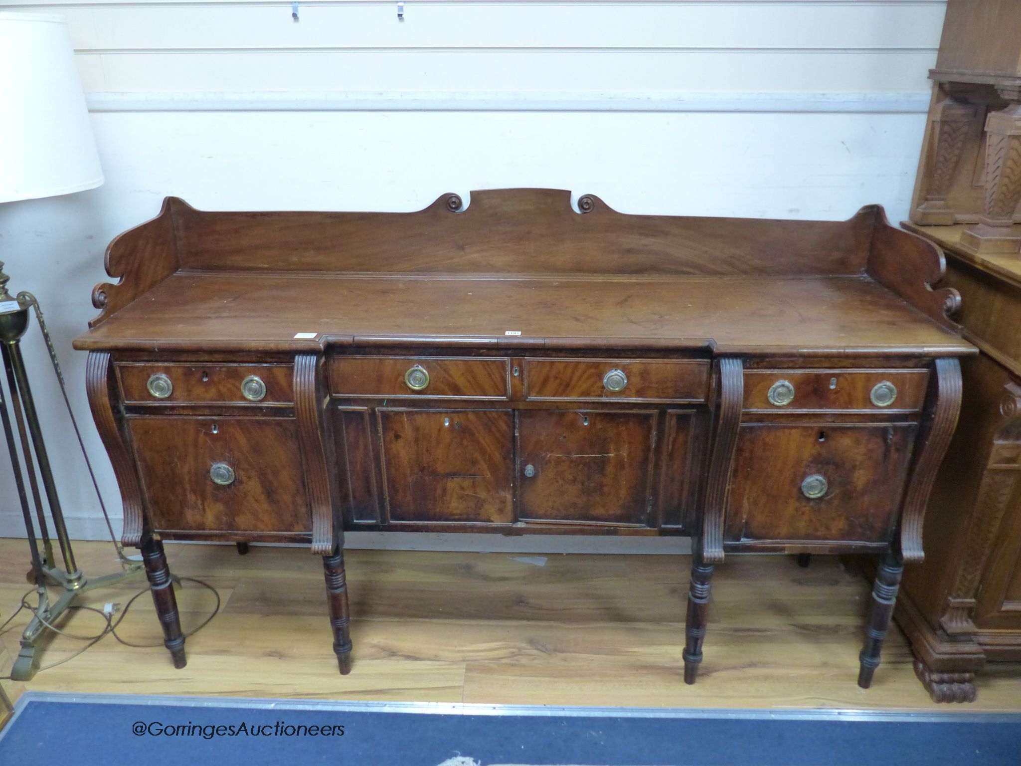 A Regency mahogany inverse breakfront sideboard. W-184, D-60, H-108cm.